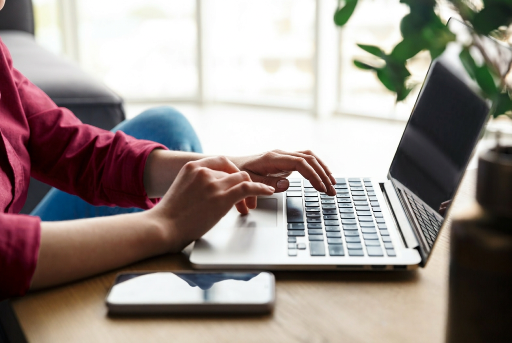 Student typing on a laptop